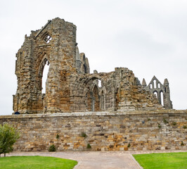 Ancient abbey ruins on the clifftop of a seaside town in the Northern UK on an overcast and grey autumn day