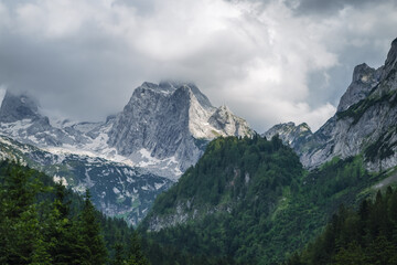 Fototapeta na wymiar The Dachstein summit mountain range and visible glacier ice during summertime at Gosau, Upper-Austria, Europe