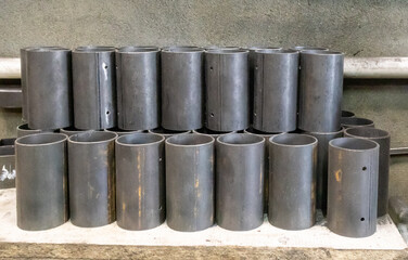 Round pipes are cut into short pieces and stacked neatly in a locksmith's shop.