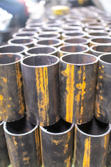 Round pipes are cut into short pieces and stacked neatly in a locksmith's shop.