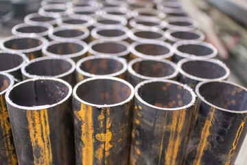 Round pipes are cut into short pieces and stacked neatly in a locksmith's shop.