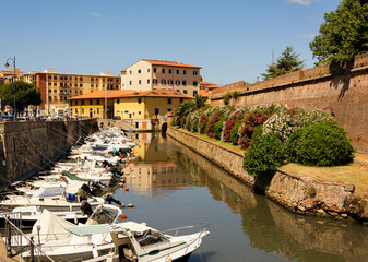 Picturesque Italian landscape. City of Livorno. View of the city canal, boats, the old city wall...
