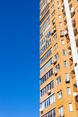 multi-storey brick apartment house and blue sky