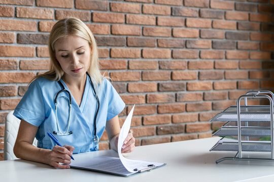 Qualified Nurse In Blue Medical Uniform Filing Papers