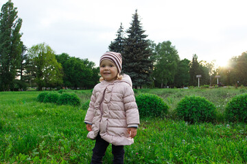Little cute girl in the park, blurred background