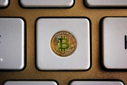 Bitcoin cryptocurrency coin on a computer keyboard