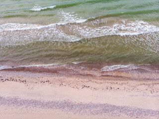 Areal view of baltic sea shore with baltic sea, sand and many rocks.