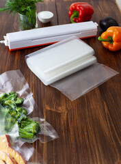 A roll of empty small vacuum bags next to a vacuum cleaner