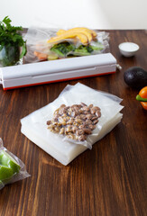 A pack of empty vacuum bags and packed vacuum nuts with vegetables