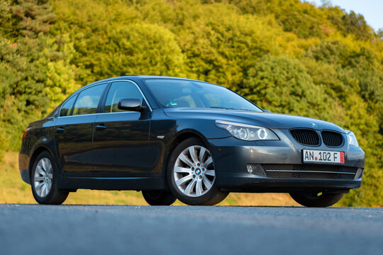 Cluj-Napoca, Romania -Octomber 19, 2018 : Isolated BMW serie 5, model e60, year 2007, sedan. Iconic luxurious german car with xenon lights equipment, alloy wheels, chrome ornaments. Autumn photo 