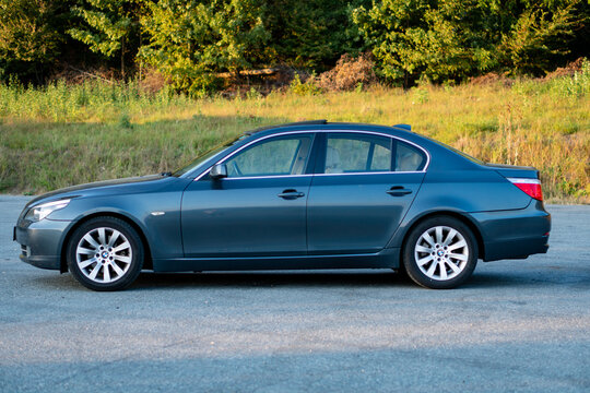 Cluj-Napoca, Romania -Octomber 19, 2018 : Isolated BMW serie 5, model e60, year 2007, sedan. Iconic luxurious german car with xenon lights equipment, alloy wheels, chrome ornaments. Autumn photo 