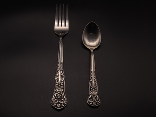 Spoon, fork on a dark background