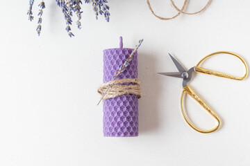 DIY natural beeswax candle with lavender aroma. Purple useful candle