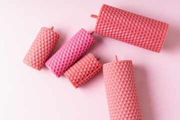 Group of pink handmade beeswax candles different sizes. Top view