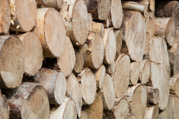 stacked chopped firewood. timber bars at a sawmill. wood background	