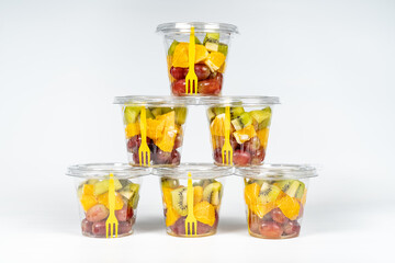Peeled and cut fruit containers ready to eat in a healthy diet.
