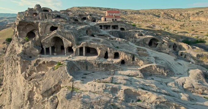 Flying during sunset over the cave city of Uplistsikhe in Georgia. Without people.