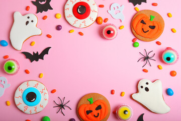 Halloween sweets on colored background close up top view with place for text