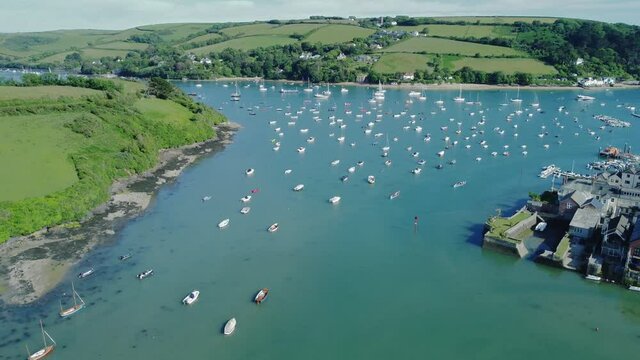 small boats on the blue water of Batson creek in Salcombe, a popular resort town in South Hams district of Devon.Drone aerial birds eye view shot