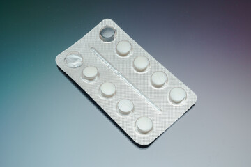 medical blister pack with white pills on background