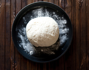 Process of raising the dough in a special basket. Dough made from natural sourdough. Wheat dough. Fermentation. Top view.	