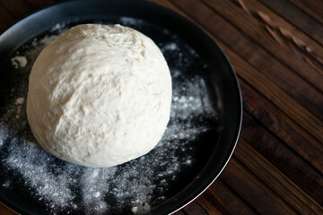 Process of raising the dough in a special basket. Dough made from natural sourdough. Wheat dough. Fermentation. Top view.	