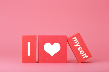 I love myself modern minimal concept in pink and red colors. Simple elegant composition with toy cubes