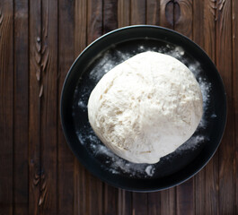 Process of raising the dough in a special basket. Dough made from natural sourdough. Wheat dough. Fermentation. Top view.	