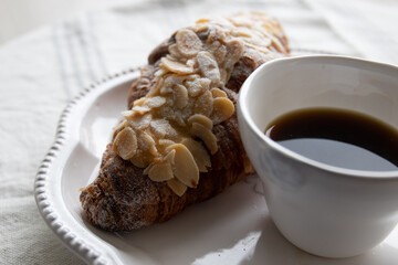 Almond Croissant with a cup of hot coffee for Breakfast 