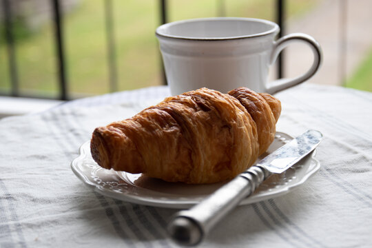 A cup of Coffee with Croissant for Beakfast