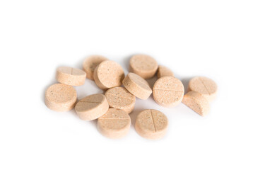 Natural plant pills on a white background. Round herbal tablets close-up. Healthcare and medicine. Homeopathy and Alternative Medicine	