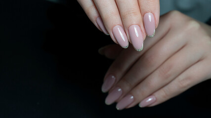 Womans hands with nude beige pink nail design. Manicure, fashion and beauty salon concept