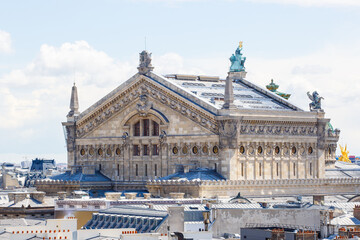 Fototapeta na wymiar The Opera Garnier of Paris and city roofs, France