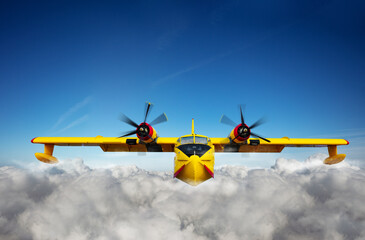 Yellow waterplane fly in clouds at high altitude