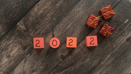 christmas numbers 2022 on a wooden background with a place for text , a Christmas banner