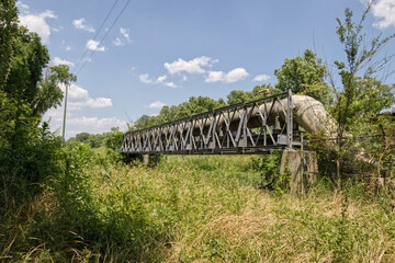 Distant view of a  metal frame bridge supporting pipeline