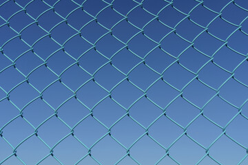 Fototapeta na wymiar Against the background of a blue sky, a mesh metal mesh of blue color.