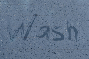 On the dirty glass, raindrops and the inscription - wash made by your finger