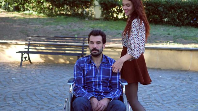 to be helpless, disability - woman jokes heavily with a man with a disability