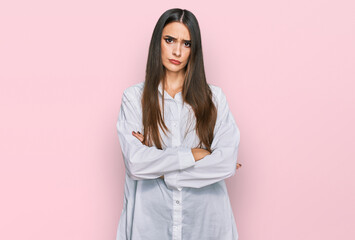 Young beautiful woman wearing casual white shirt skeptic and nervous, disapproving expression on...