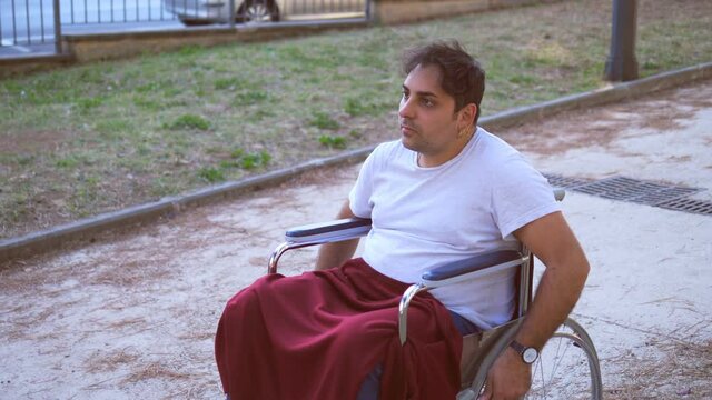 disability, problem-man using wheelchair at the mercy of an intrusive friend