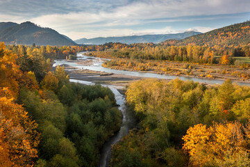 Obraz premium Aerial View of the Magnificent Nooksack River Valley During the Autumn Season. Fall color adds to this beautiful scenic drive up the Mt. Baker Highway to the recreation area of the Pacific Northwest.