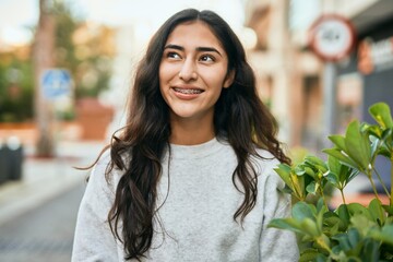 Fototapeta premium Young middle east girl smiling happy standing at the city.