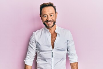 Middle age man wearing casual clothes with a happy and cool smile on face. lucky person.