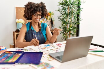 Young african american woman smiling confident having online draw class at art studio