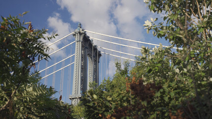 Picture of the iconic Brooklyn Bridge in New York City, taken from the Brooklyn shoreline looking...