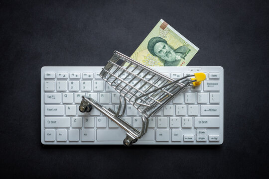 Iranian Currency, White Computer Keyboard, Miniature Shopping Cart, Black Background, Online Shopping Concept In Stores, Low Prices