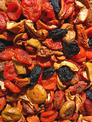 Box of dried apricots, apples and prunes. Top view on dried fruits - tasty and healthy snack.