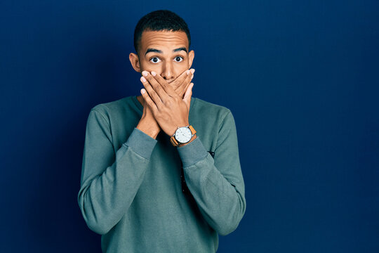 Young african american man wearing casual clothes shocked covering mouth with hands for mistake. secret concept.