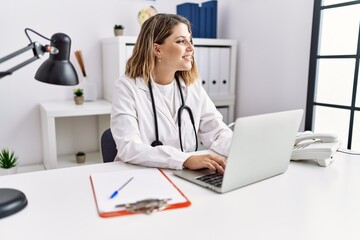 Young hispanic woman wearing doctor stethoscope working at clinic